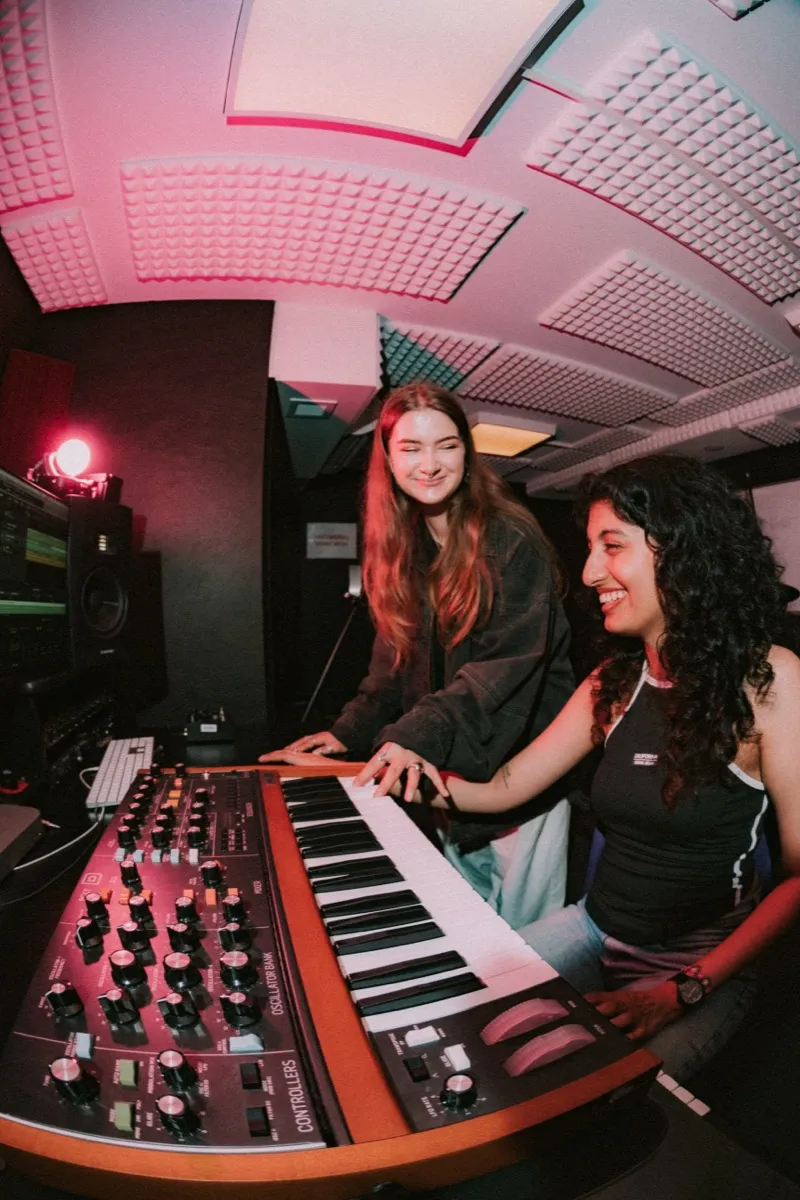 Students collaborating on a funded music production project