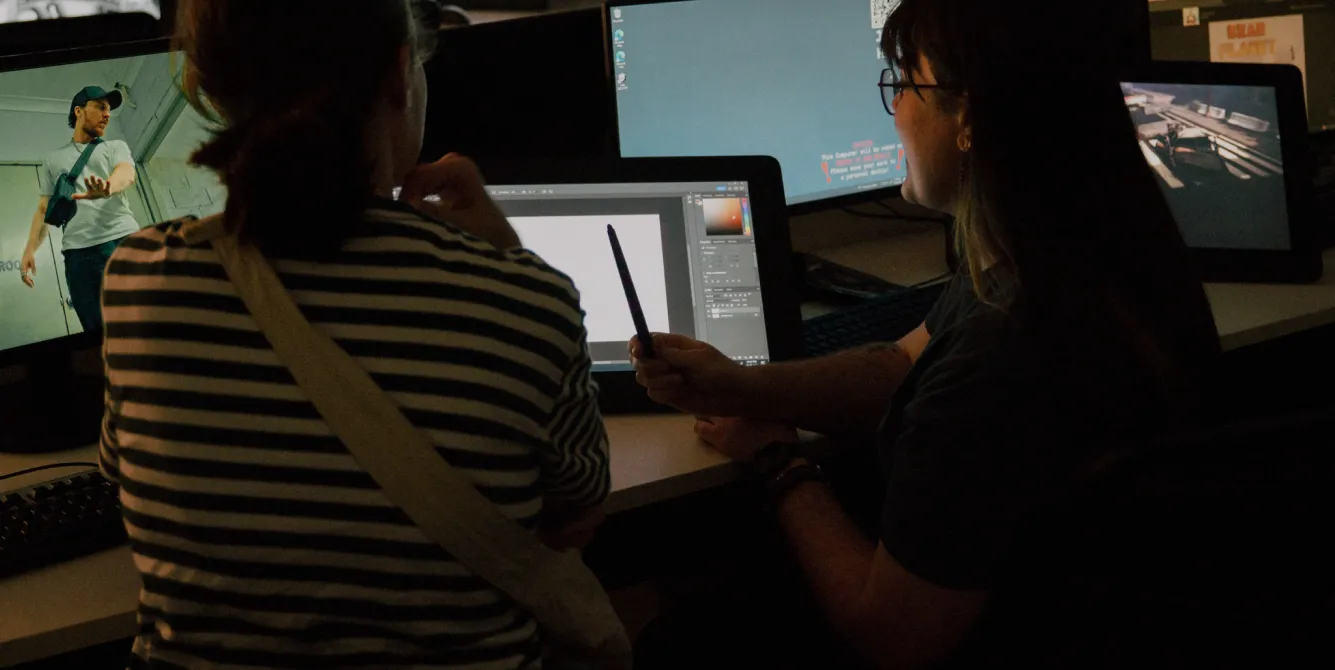Two students collaborating on a digital design project